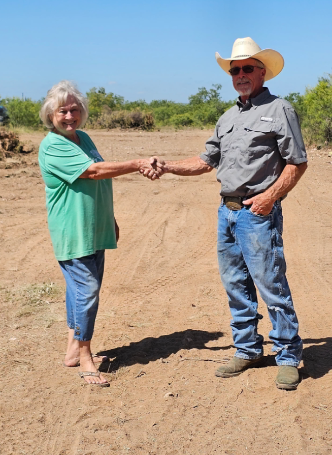 M2 Land Clearing owner shaking hands with a satisfied customer on a freshly graded site